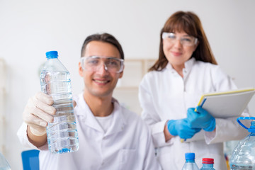 Two chemists working in the lab