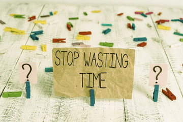 Text sign showing Stop Wasting Time. Business photo text advising demonstrating or group start planning and use it Scribbled and crumbling sheet with paper clips placed on the wooden table