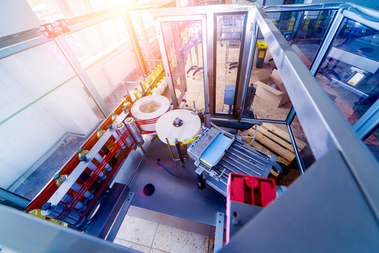 Automatic labeling machine during operation. Factory for the production of vegetable oil.