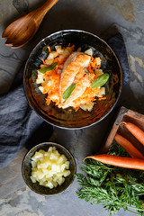 Grilled chicken breasts, with pineapple and carrot garnish