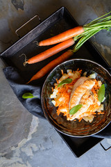 Grilled chicken breasts, with pineapple and carrot garnish