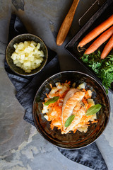 Grilled chicken breasts, with pineapple and carrot garnish
