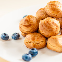 profiteroles with Blueberries on a white plate