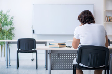 Young male student in front of whiteboard