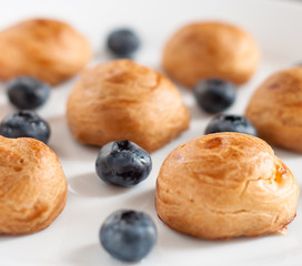 profiteroles with Blueberries on a white plate