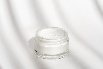 White facial cream jar. Cosmetic moisturizing product. Skin and body care, moisture lotion, wellness therapy mask in glass jar