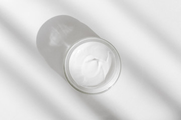 White facial cream jar. Cosmetic moisturizing product. Skin and body care, moisture lotion, wellness therapy mask in glass jar