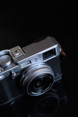 retro camera with leather strap on a black background. 