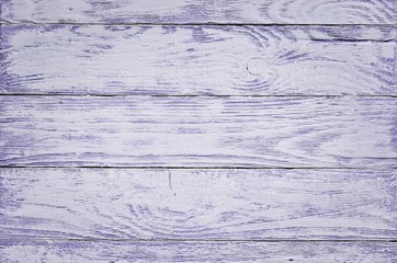 Wooden background texture. Creatively painted white and purple boards.
