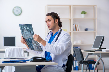 Young male doctor working in the clinic