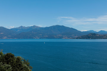 Fototapeta na wymiar Lago maggiore ore lake maggiore beautiful panorama sunny day with blue sky and fluffy clouds