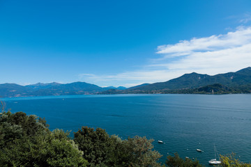Obraz premium Lago maggiore ore lake maggiore beautiful panorama sunny day with blue sky and fluffy clouds
