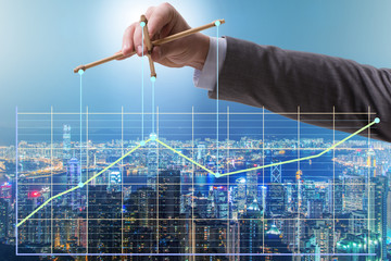 Businessman controlling the market with strings