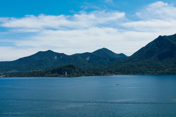 Lago maggiore ore lake maggiore beautiful panorama sunny day with blue sky and fluffy clouds