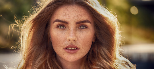 Beautiful woman with freckles on face.