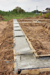 The formwork of the foundation of the future house is strengthened and filled with concrete