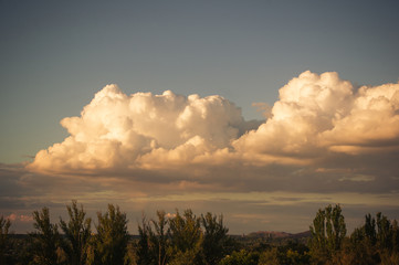 Autumn urban landscape on a Sunny day - yellow autumn trees and bright sky with clouds