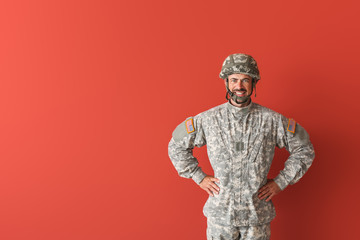 Soldier in camouflage on color background