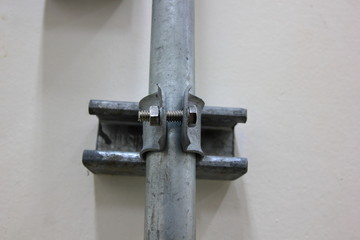 Conduit and clamp for cable electric ,Electrical Conduit with Clamp Installation on Roof ,Selective focus.