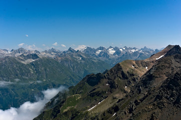 Fototapeta na wymiar Panorama of the Caucasian ridge and Elbrus viewed from a peak near dombay, 2019