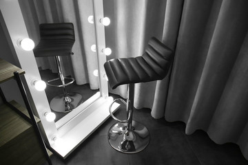 Stylish mirror and chair in modern makeup room