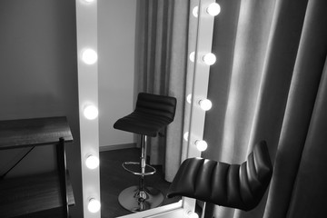 Stylish mirror and chair in modern makeup room