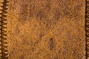 Old vintage genuine soft brown leather texture background, top layer with pores and scratches, macro, close-up
