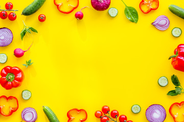 Fototapeta na wymiar colorful vegetables frame for cooking design on yellow background top view mockup