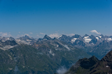 Panorama of the Caucasian ridge and Elbrus viewed from a peak near dombay, 2019