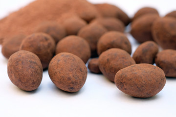 Almonds in dark chocolate. Delicious chocolates with nuts. Almonds in chocolate and cocoa close-up...