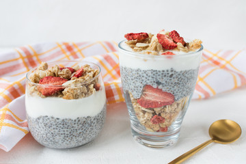 Chia pudding with almond milk, yogurt, and dried strawberries. Vegan concept.