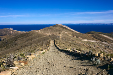 Path leading on ridge on Isla del Sol, Lake Titicaca, Bolivia. Isla del Sol (Island of the Sun) is a popular travel destination.