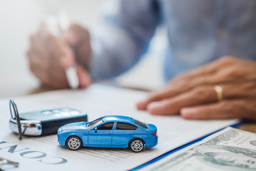 Sale agent  deal to agreement successful car loan contract with customer and sign agreement...