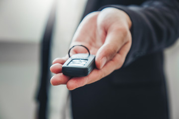 Sale agent giving Car key to customer and sign agreement contract, Insurance car concept.