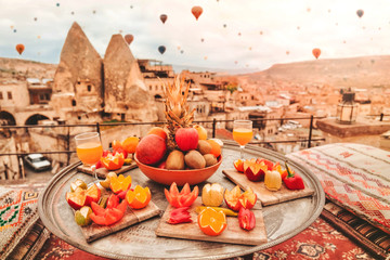 Travel in Cappadocia Colorful hot air balloons flying over the valley sunrise time with .special breakfast travel destination in Turkey - obrazy, fototapety, plakaty