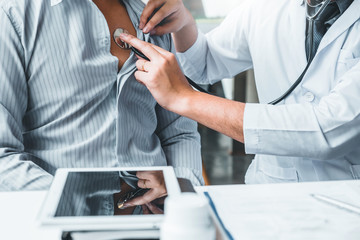 Doctor Measuring arterial blood pressure man patient Health care in hospital