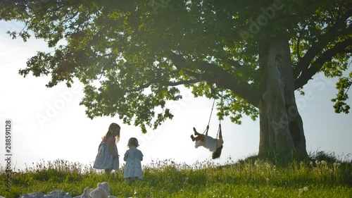 Two Sisters Run Across Clean Green Field To Their Mother