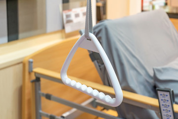 Hospital bed triangle handle with emergency remote control beacon. Accessories in retirement home...