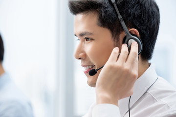 Asian man working in call center office