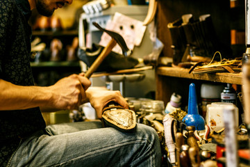 shoe repair craftsman in his studio
