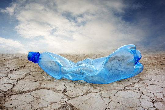 Plastic bottle on cracked ground .Environmental disaster concept