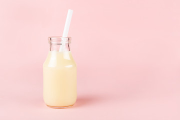 A bottle of drink on pink background.