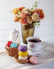 Colorful macaroons, delicious with cream and tea hot