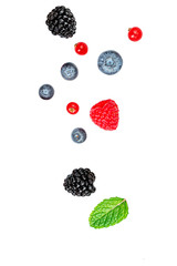 Isolated berries. Falling mix  berries isolated on white background. Raspberry, Blueberry, Blackberry. red currant and Mint leaf