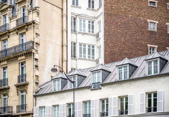 Multi-story building with balconies and wooden shutters and residential lofts