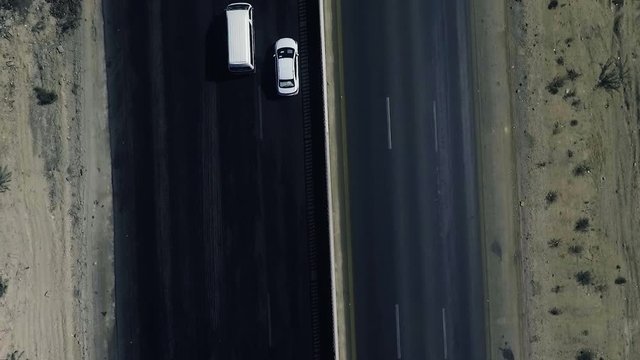 A slow mo aerial top view of traffic moving on a highway in northern areas.