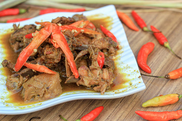 rica rica ayam kampung or  Indonesian native chicken with spicy seasonings, oily gravy and chunks of chili