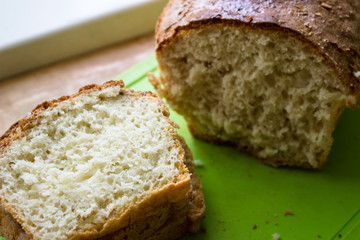 Sliced ​​bread on the table. Bread on a green board.