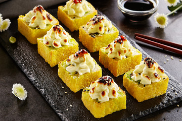 Hot roll in tempura with baked cheese cap and unagi sauce