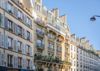 Fototapeta premium Paris street residential apartment buildings with balconies and window shutters